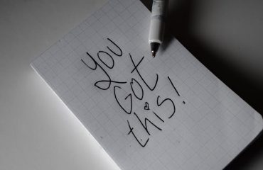 Inspirational handwritten note on graph paper with pen. Encouraging words 'You got this!'
